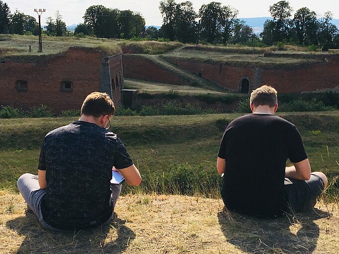 Participants drawing whilst looking at Theresienstadt walls